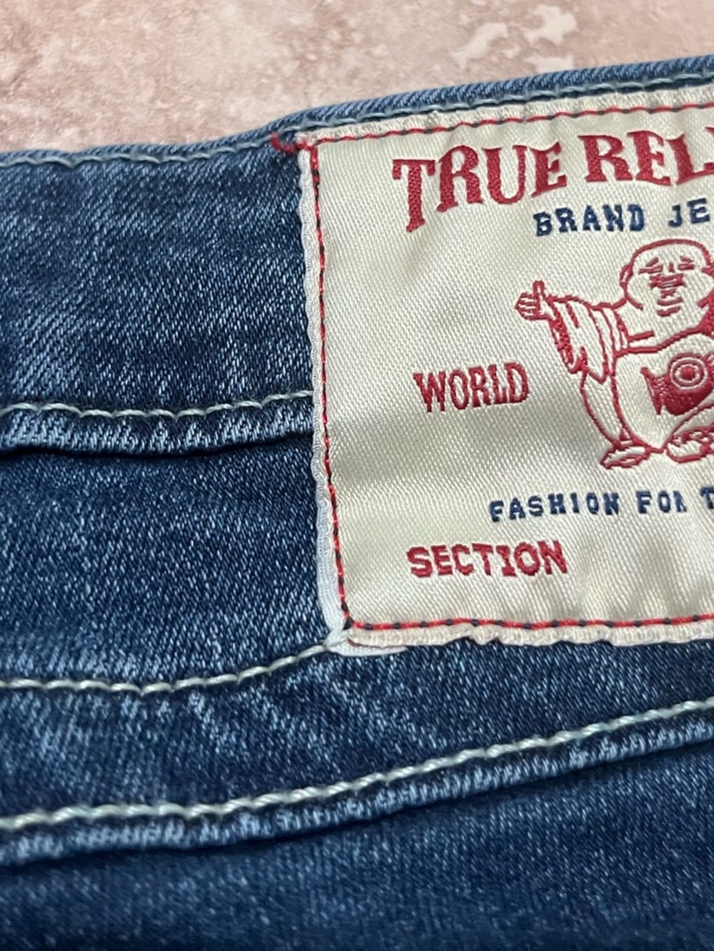 True Religion Blue Denim with Red and White Logo Patch